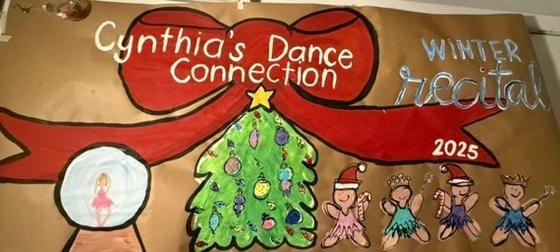 Hand-painted dance recital banner with a decorated Christmas tree in the center, ballerinas in Santa hats and tutus, a snow globe with a dancer inside, and a red ribbon across the top with the studio name in script